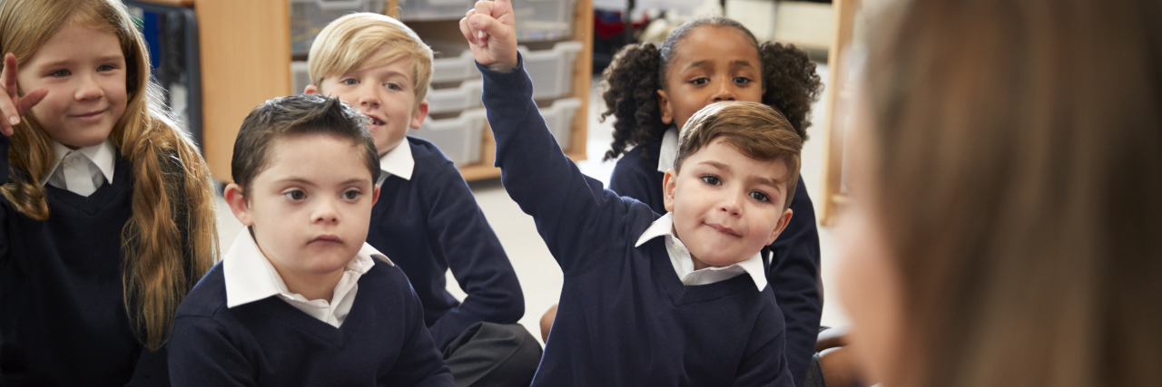 How Teachers and Parents Can Collaborate to Achieve Inclusion Teacher with students including one with Down syndrome.