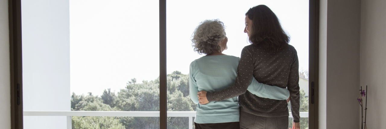 Growing Up With a Parent With a Brain Injury Mother and daughter embracing while looking out a window.