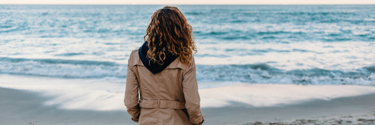 A woman looking at the ocean