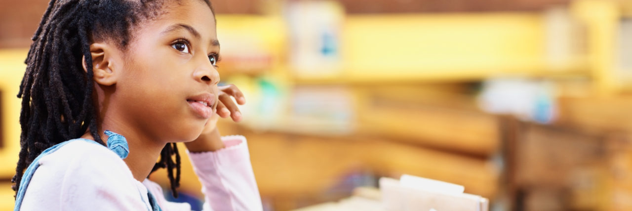 What You Need to Know About IEPs and 504s at School Contemplative girl writing notes in the classroom