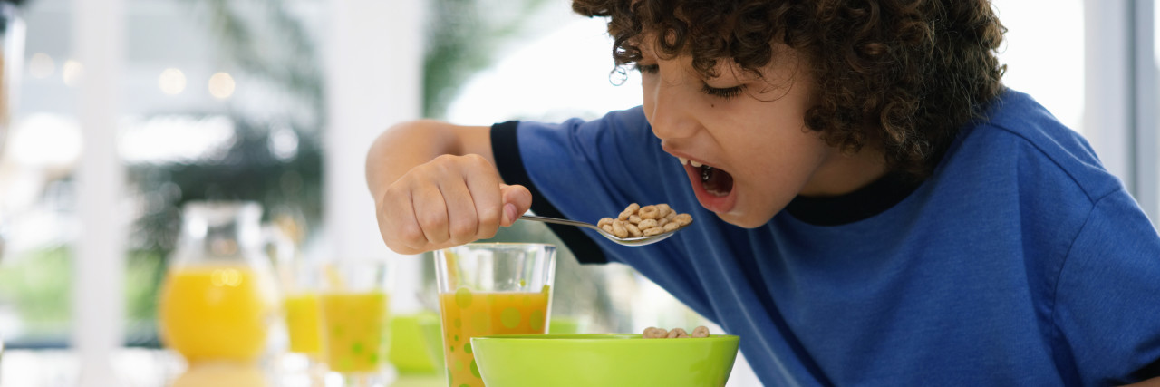 Boy at table eating cereal
