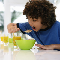Boy at table eating cereal