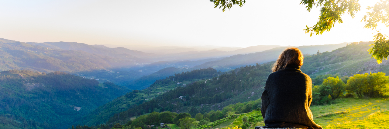 How I See Healing as a Person With Migraine Scenic view of woman watching sunset in mountains, Peneda-Geres National Park, northern Portugal.