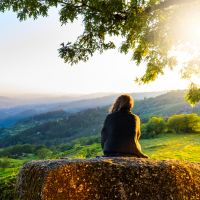 Scenic view of woman watching sunset in mountains, Peneda-Geres National Park, northern Portugal.