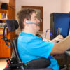 man in wheelchair works on computer