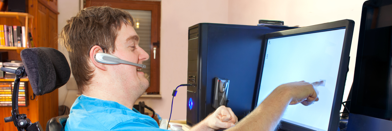 An Overview of the Laws That Help Protect Students With Disabilities man in wheelchair works on computer