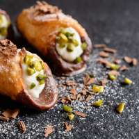 Traditional Sicilian cannoli stuffed with ricotta and pistachios.
