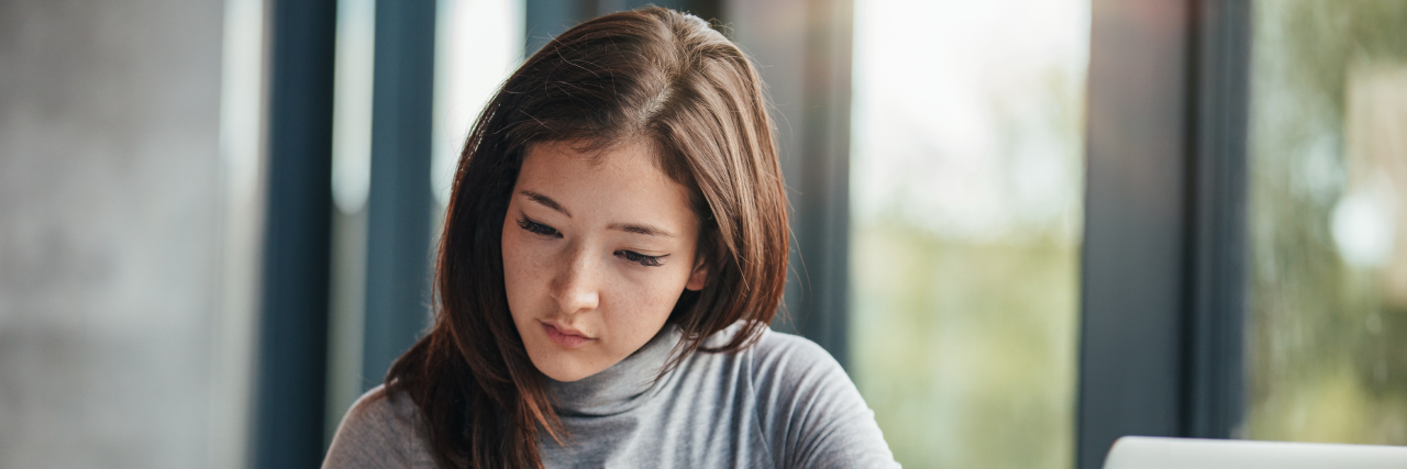 Woman taking down notes in diary