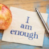 I am enough positive affirmation - handwriting on a paper with a fresh apple nearby.
