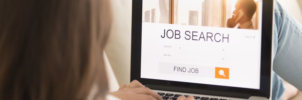 Job Hunting With Chronic Illness Woman sitting on couch looking for a job online.