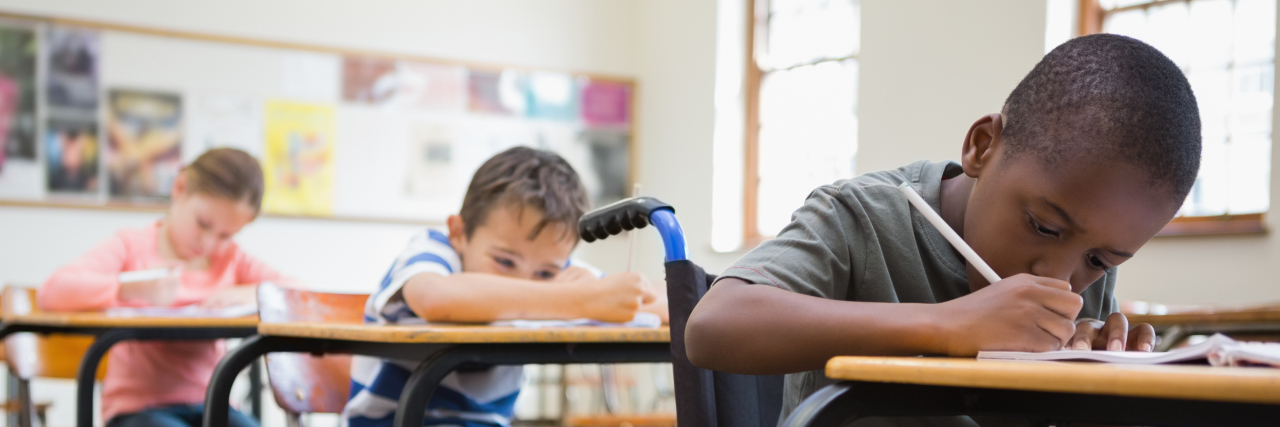 What to Do If Your IEP or 504 Isn't Being Followed Cute pupils writing at desks in classroom