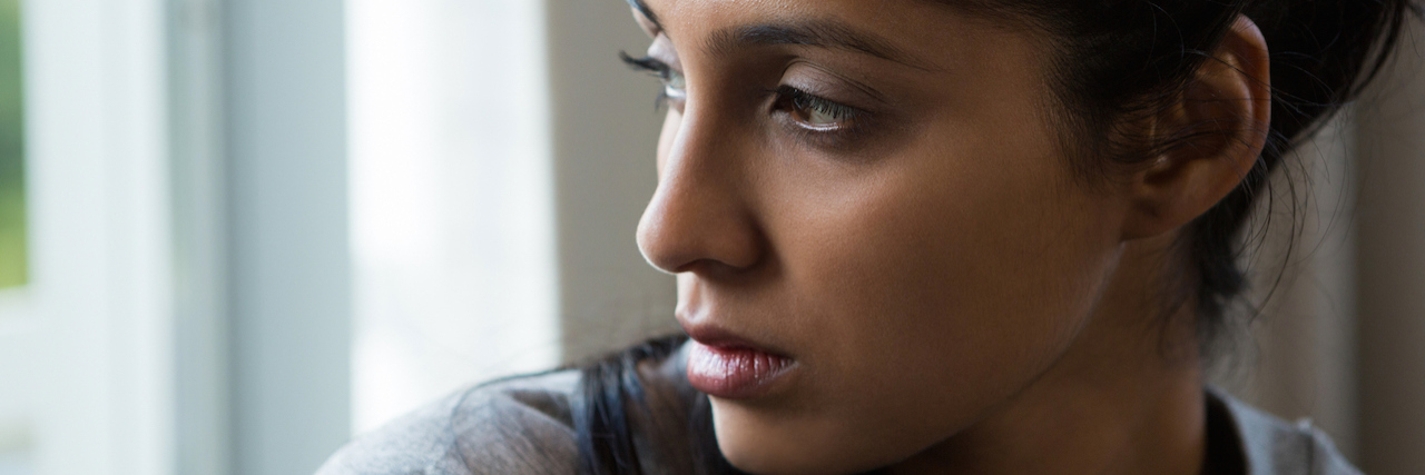 What You Should Consider Before Connecting Violence and Mental Illness A woman looking to the side