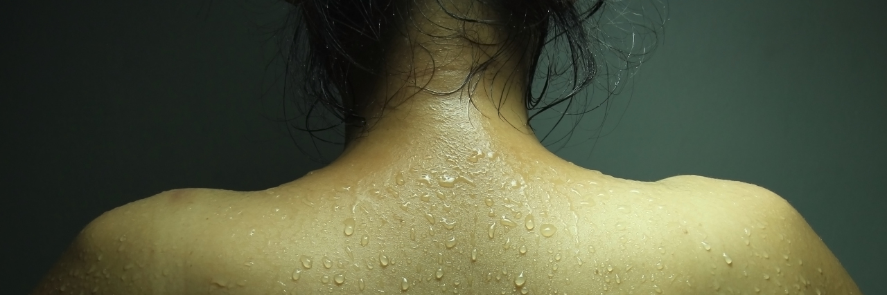 photo of a woman's back with beads of sweat visible