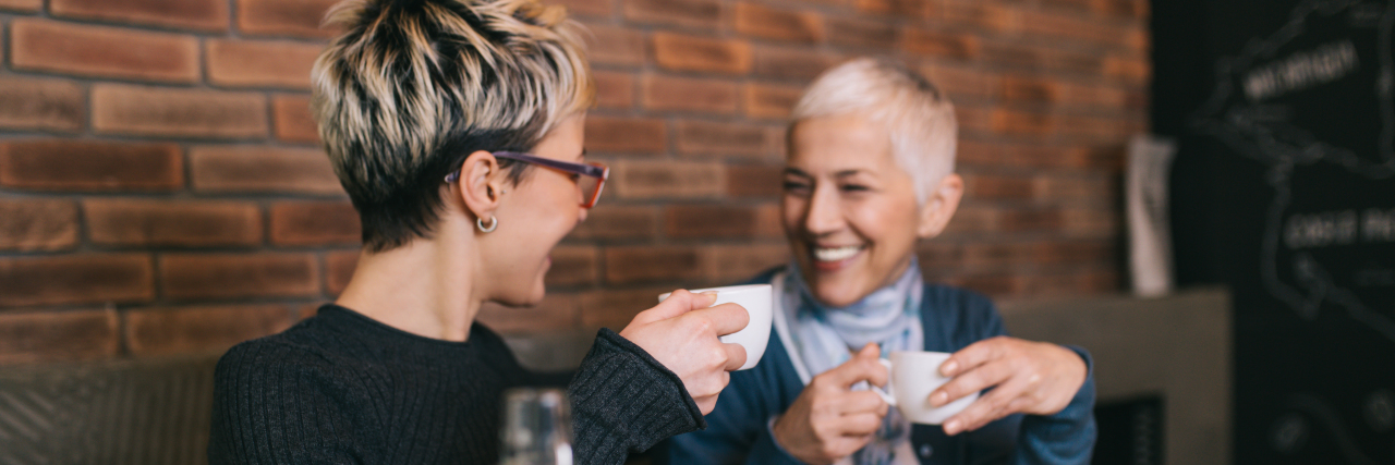 How to Support Someone With a Chronic Illness Mother and daughter in cafe drinking coffee.