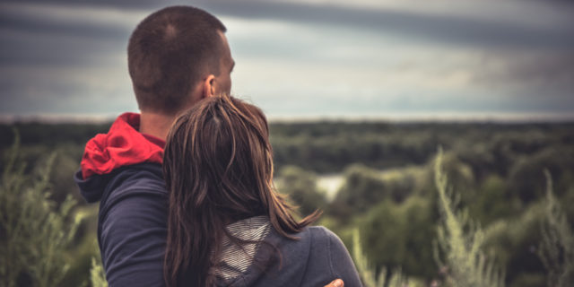 How the U.K. Benefits System Is Harming Those It Should Be Helping Young couple embracing in a field.