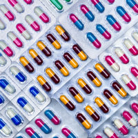 Assortment of colorful pills in blister packs.