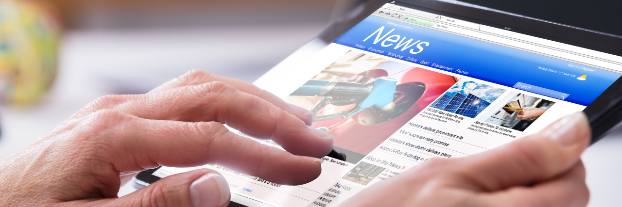 Improving News Headlines About Disability Person reading news on a tablet.