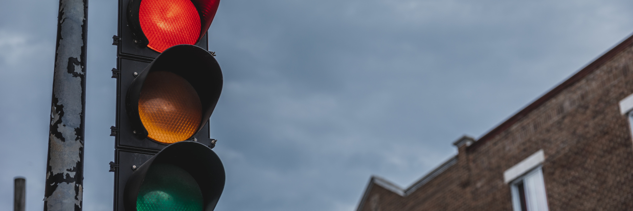 Developing Self-Esteem as a Person Who Stutters Stoplight on a cloudy day.