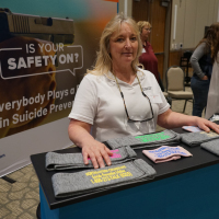 Northeastern Counseling Center prevention specialist Robin Hatch gave out gun socks screen-printed with the National Suicide Prevention Lifeline information at the Vernal Gun & Knife Show in Vernal, Utah. (Erik Neumann/KUER)