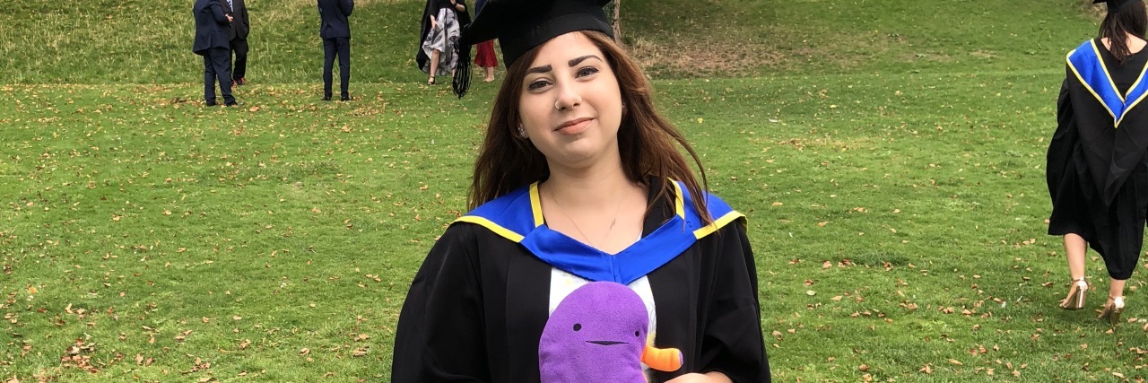 6 'Spoonie' Tips to Remember If You're Worried About Attending College  the author standing proudly in her cap and gown at graduation