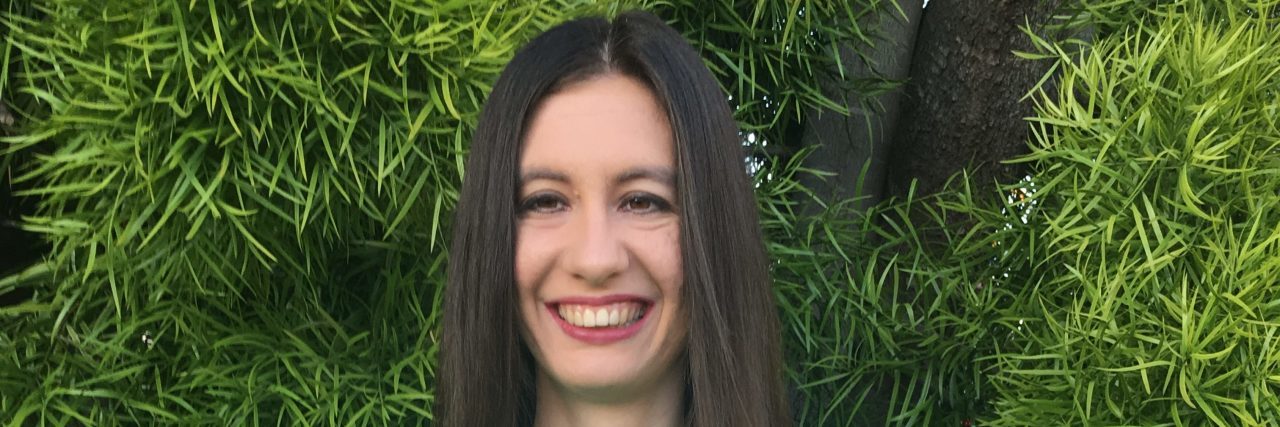 Increasing Media Representation of Mild Cerebral Palsy Kelly wearing a Go Green for CP t-shirt.