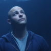 photo of filmmaker Nick Cavalier looking up in blue light
