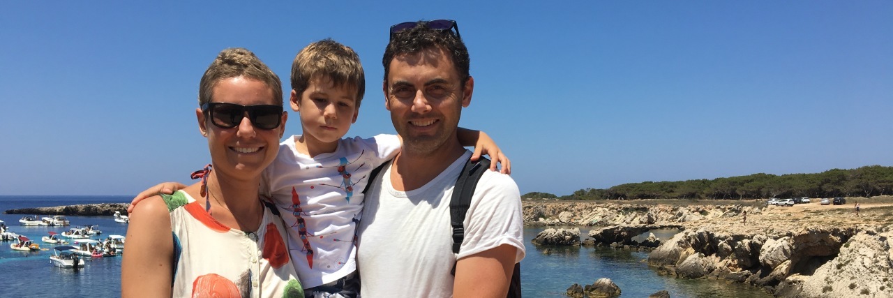 How Infertility Caused by Non-Hodgkin's Lymphoma Affected Me mom, dad and two small kids on cliff overlooking ocean