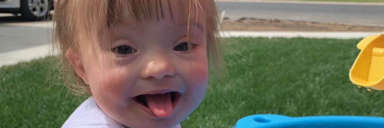 To the Women Who Delivered My Daughter's Down Syndrome Diagnosis little girl with Down syndrome playing at a water table