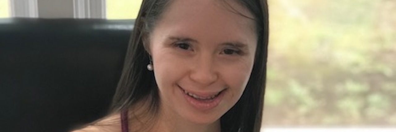 We Need Teachers to Become Advocates for Kids With Disabilities Woman with Down syndrome smiling at camera