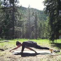photo of woman in forest in lizard pose