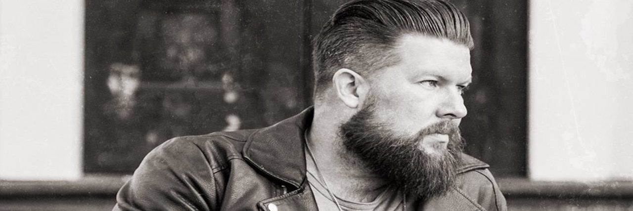 Zach Williams' Fear Is A Liar Is Wrong Christian artist Zach Williams sits with his legs crossed looking to the side.