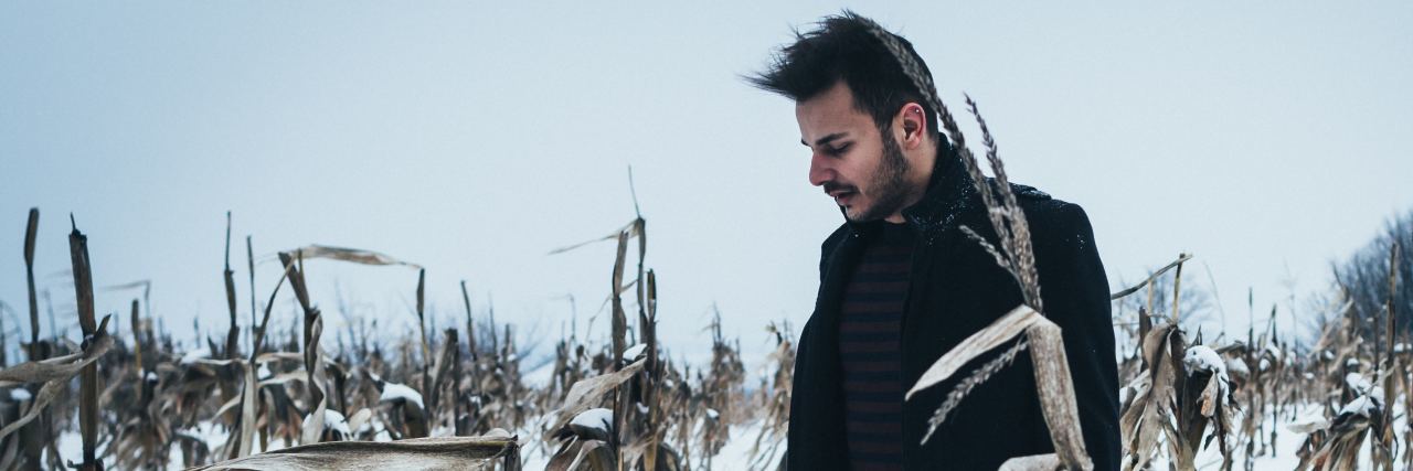 Having Depression as a US Army Veteran photo of man standing in winter cornfield