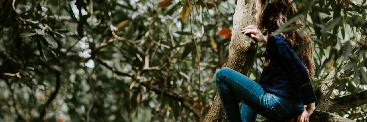 Struggling to Cope With My Body in Eating Disorder Recovery photo of young girl climbing a tree