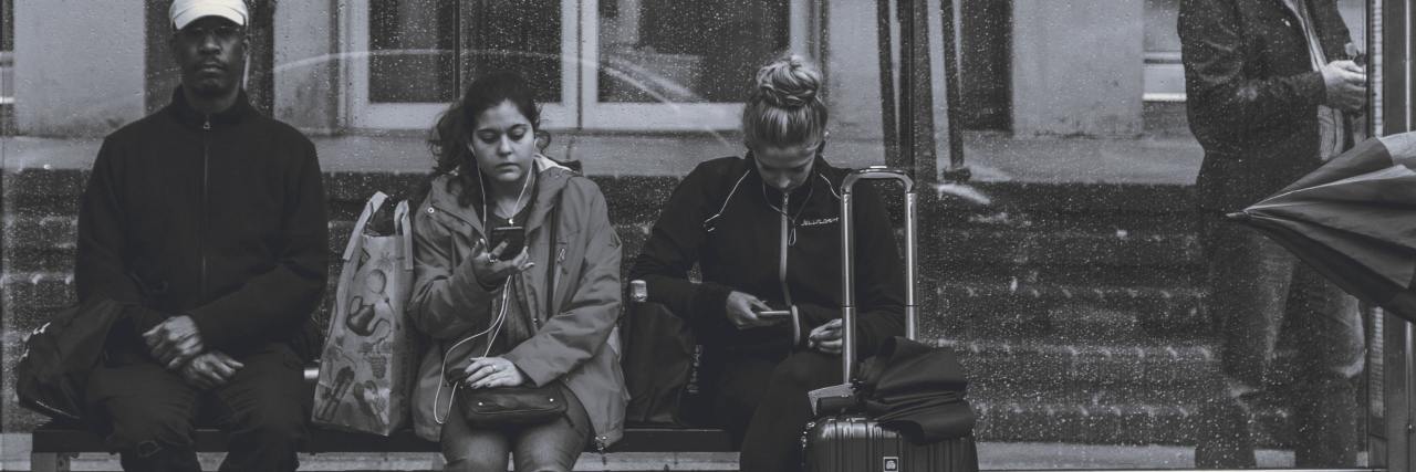 What to Know About Living With Panic Attacks black and white photo of group of people waiting for train or bus