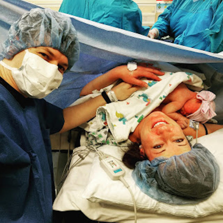 new parents cradling baby after c-section