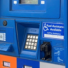 Gas pump with phone number to call for assistance if you have a disability.