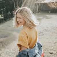 photo of blonde woman smiling in bright light outdoors