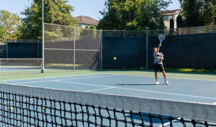 While at tennis practice, Sam wears a fanny pack around his waist that holds his insulin pump, cellphone and a credit-card-sized device that transmits commands to the pump.