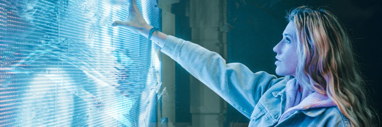 The Ways Anxiety and Depression Can Be Like Superpowers photo of blonde woman holding out hand to wall of light