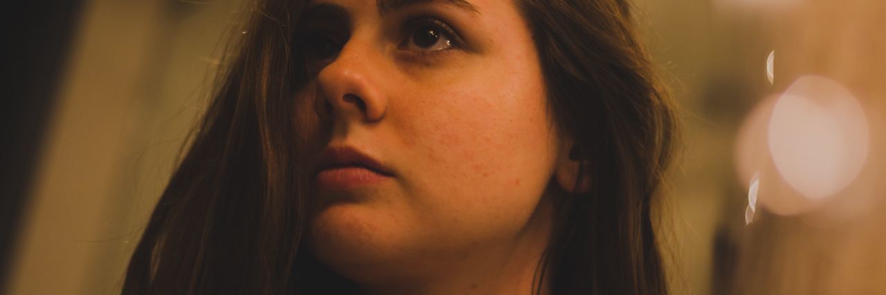 Feeling Like You Have to Choose Between Mental Stability and Weight photo of young woman with dark hair looking into mirror upset