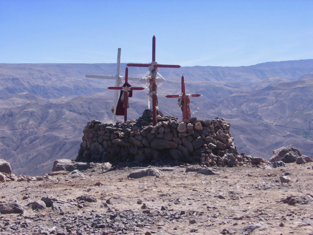 photo of cross offerings at summit of Cerro Baul mountain in peru