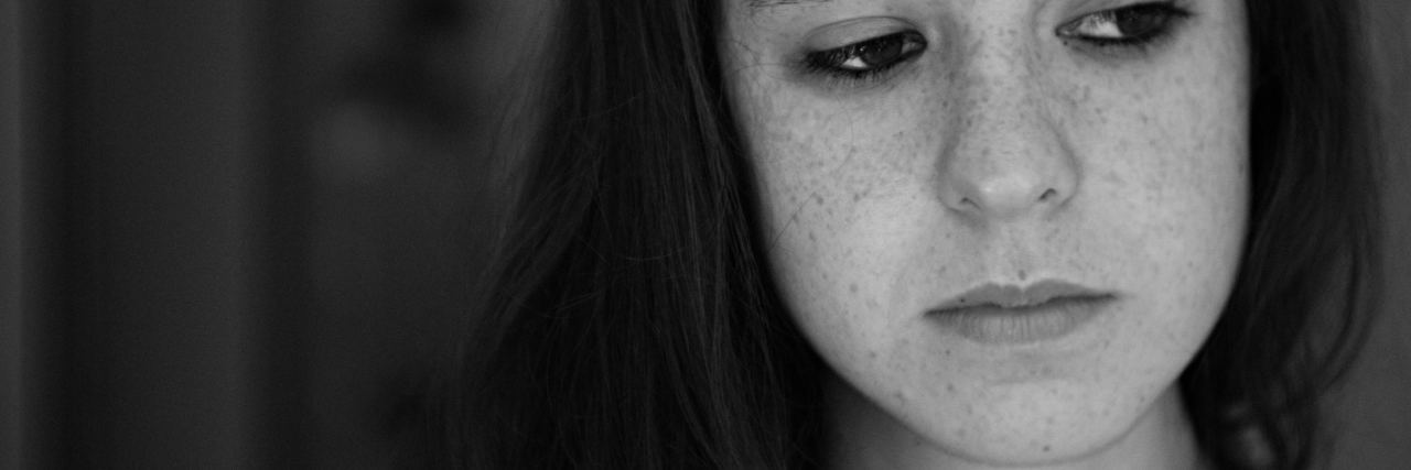 What to Know If You Haven't Experienced a Sexual Assault black and white photo of woman looking upset or sad and away from camera