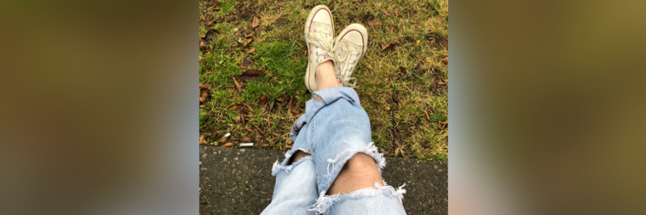 Finding Strength in Sadness as Someone With Chronic Illness Photo of contributor's legs crossed, sitting outside