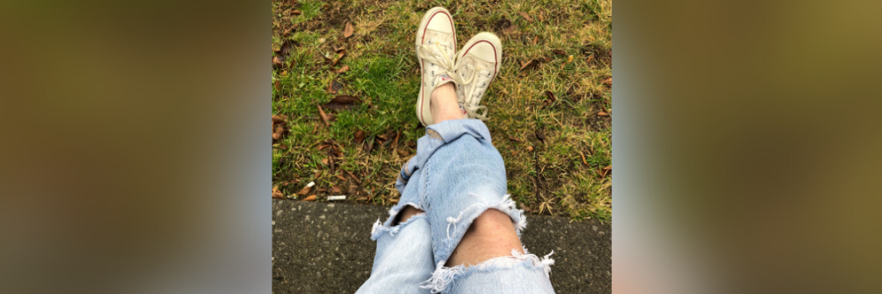 Photo of contributor's legs crossed, sitting outside