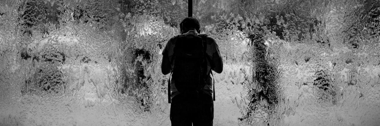 The Loneliness I Experienced After My Cancer Treatment Ended man standing in front of glass doors