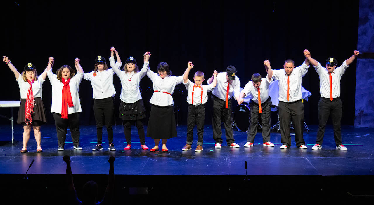 the Improvaneers cast take a bow onstage