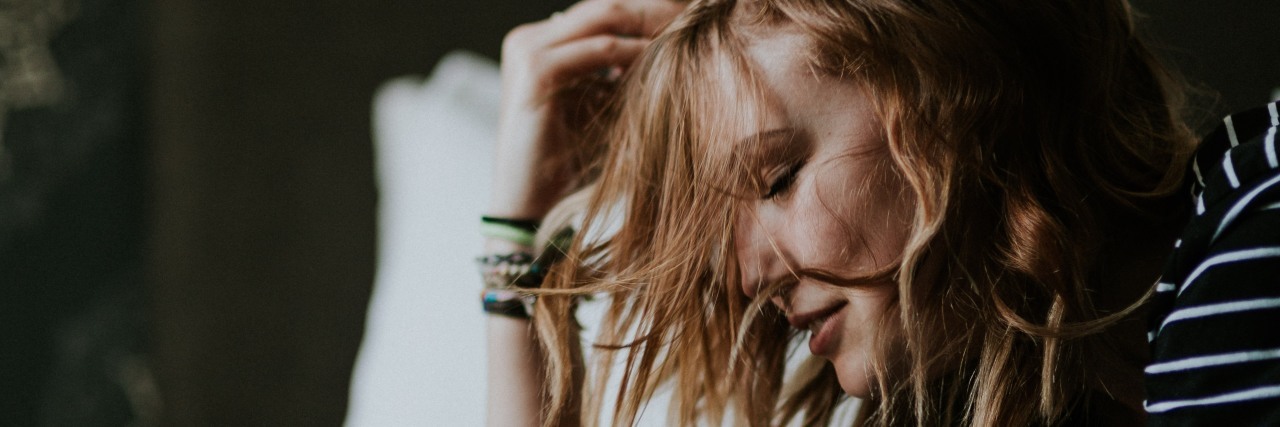 Why Thyroid Cancer Is Not 'the Good Cancer' woman laying on bed on stomach