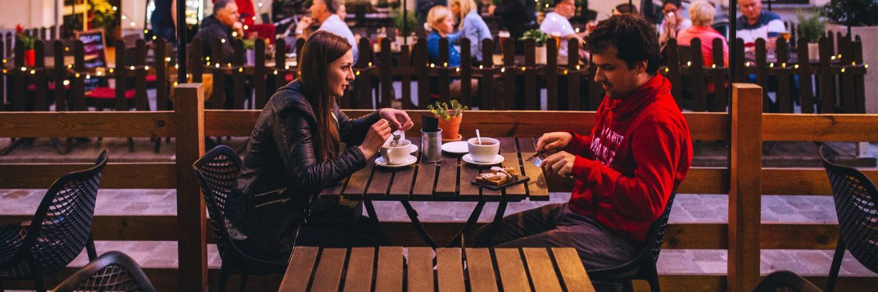 Modern Dating Advice If You Have Anxiety photo of young man and woman on date sitting at table facing each other