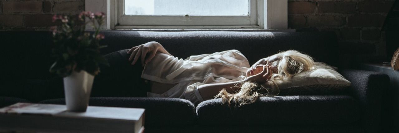 17 'Normal' Things That Are Difficult When You Live With Chronic Pain woman with blonde hair laying on couch during day