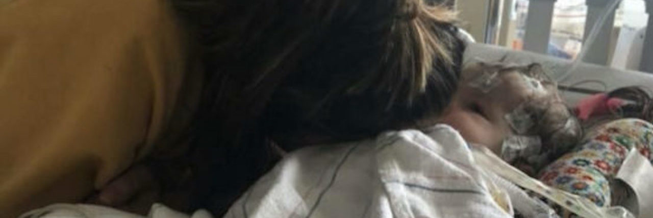 Deciding to Enroll in Hospice for Your Child: What to Know the author and her child, laying next to each other